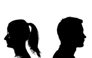 black silhouette of a man and woman standing back to back