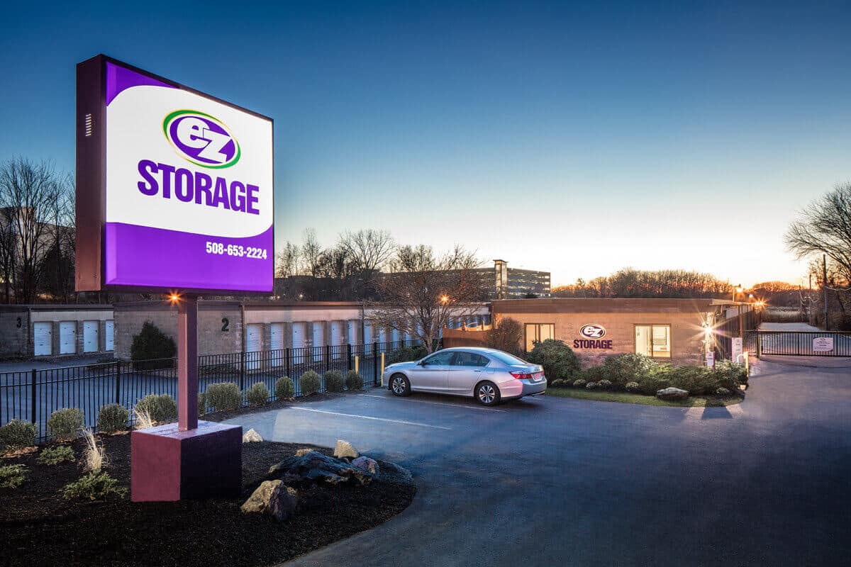 self storage building at night with a lighted sign with the text 'ez storage'