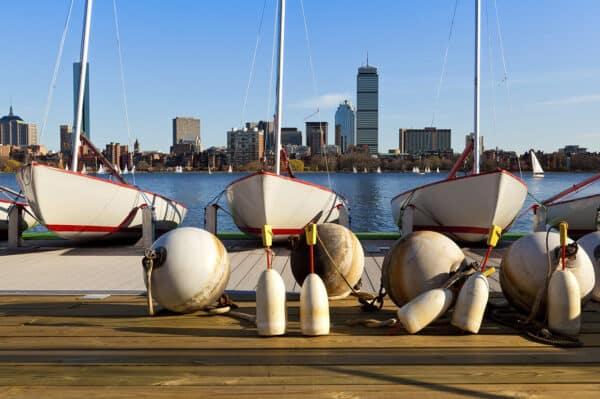 three boats tied to the dock in Boston harbor