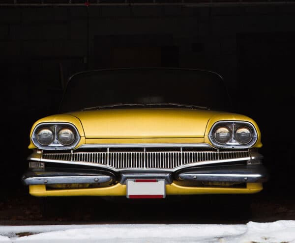 yellow, classic vehicle in storage garage