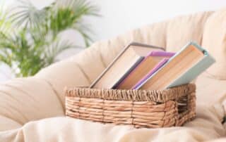 three books in a basket on a chair