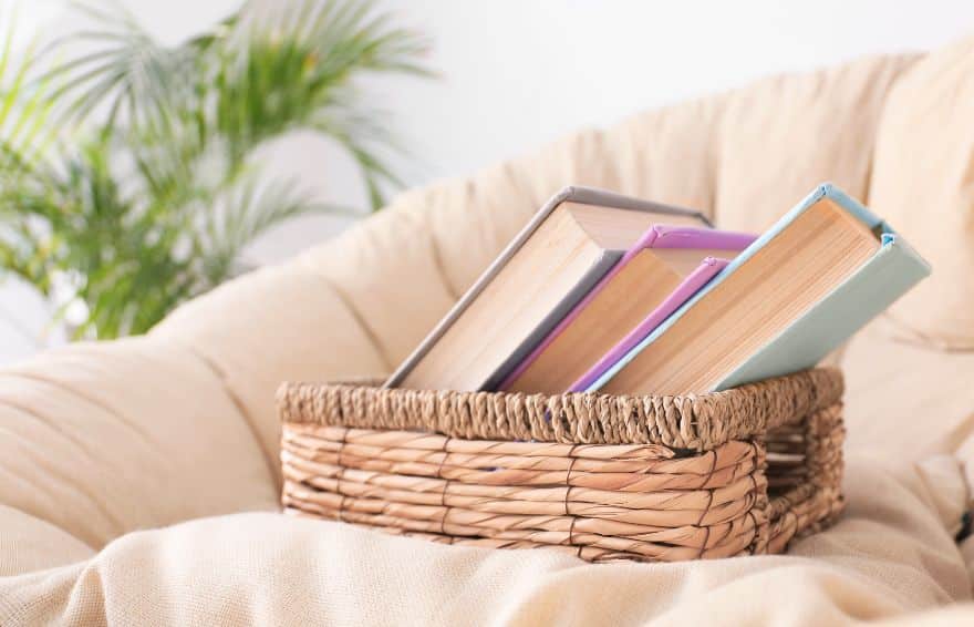 three books in a basket on a chair